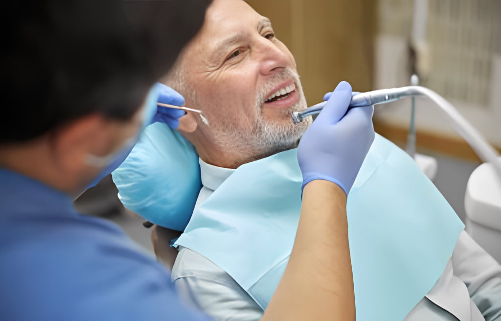 Smiling patient receiving professional dental care