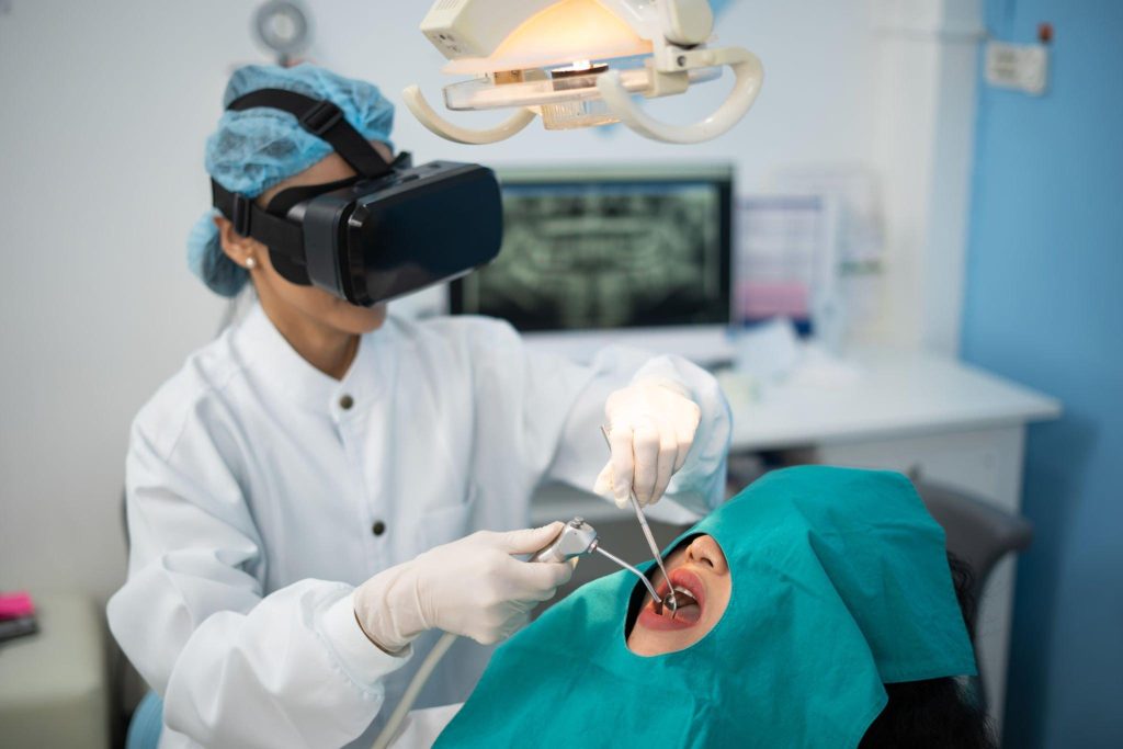 Dentist using virtual reality technology in a dental procedure