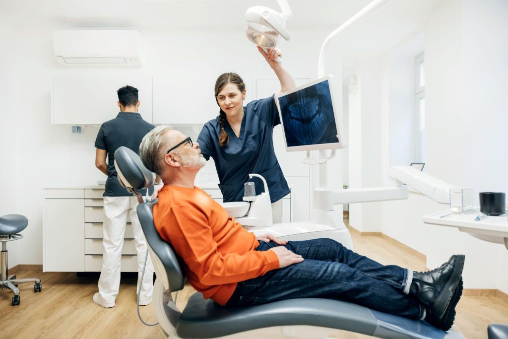 Patient in dental office receiving care from professionals