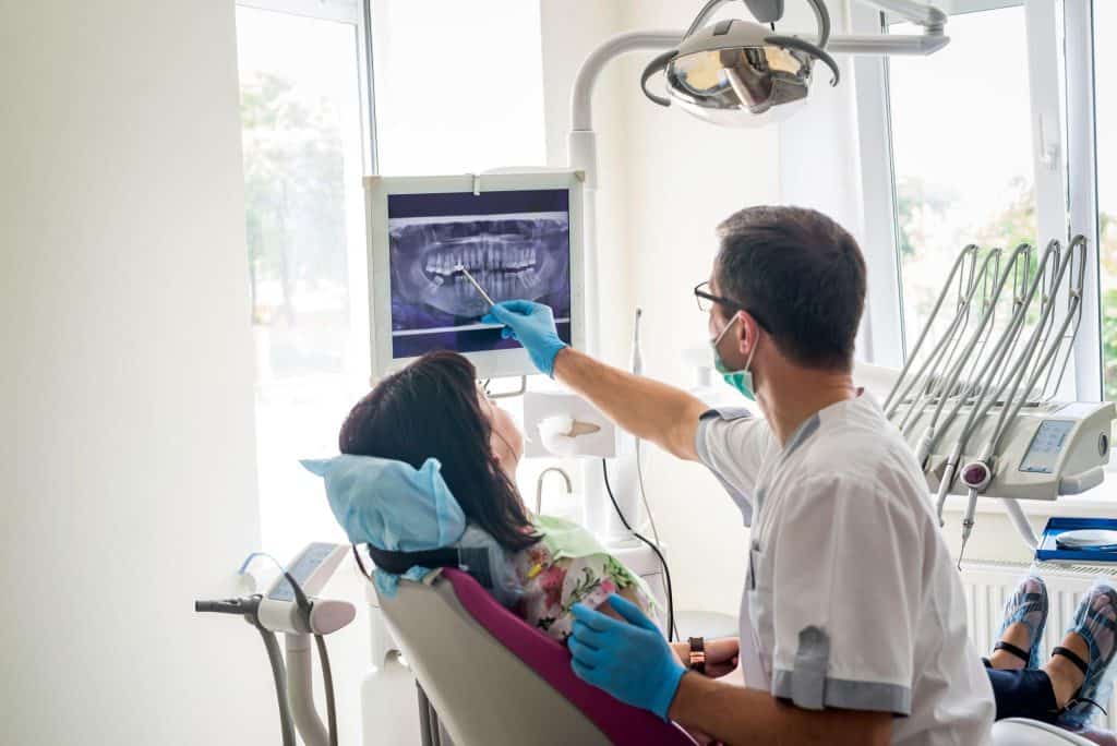 Dentist explaining X-ray results to a patient