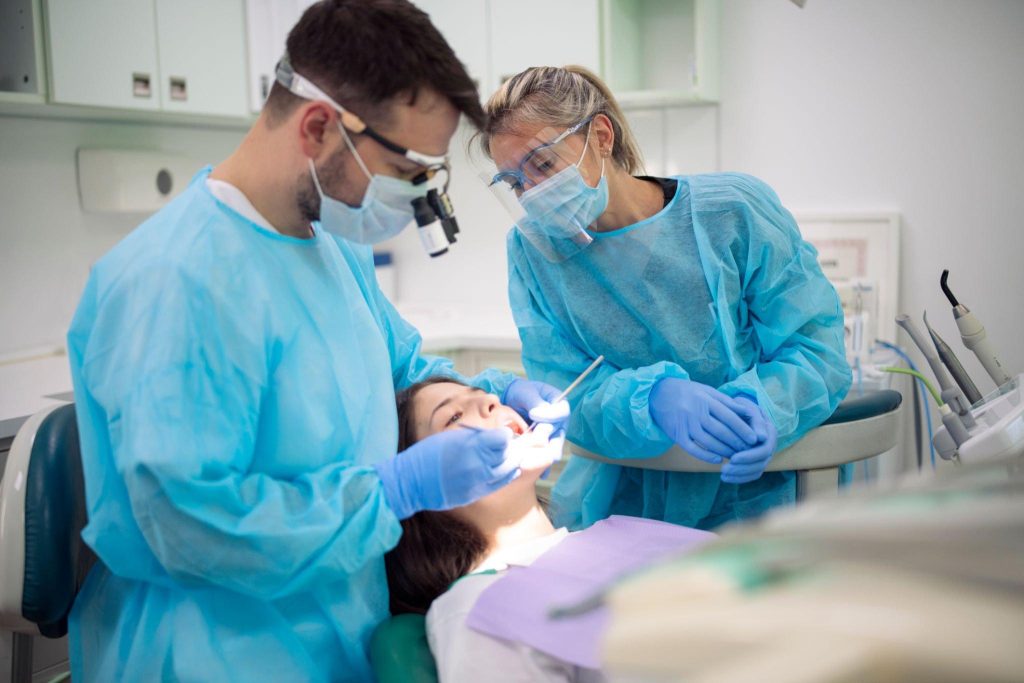 Professional dentists performing a dental procedure in a modern clinic